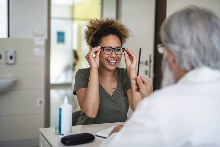 Woman testing out her new eyeglasses in ophthalmology office