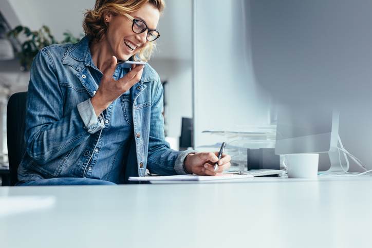 Smiling young businesswoman working at her desk