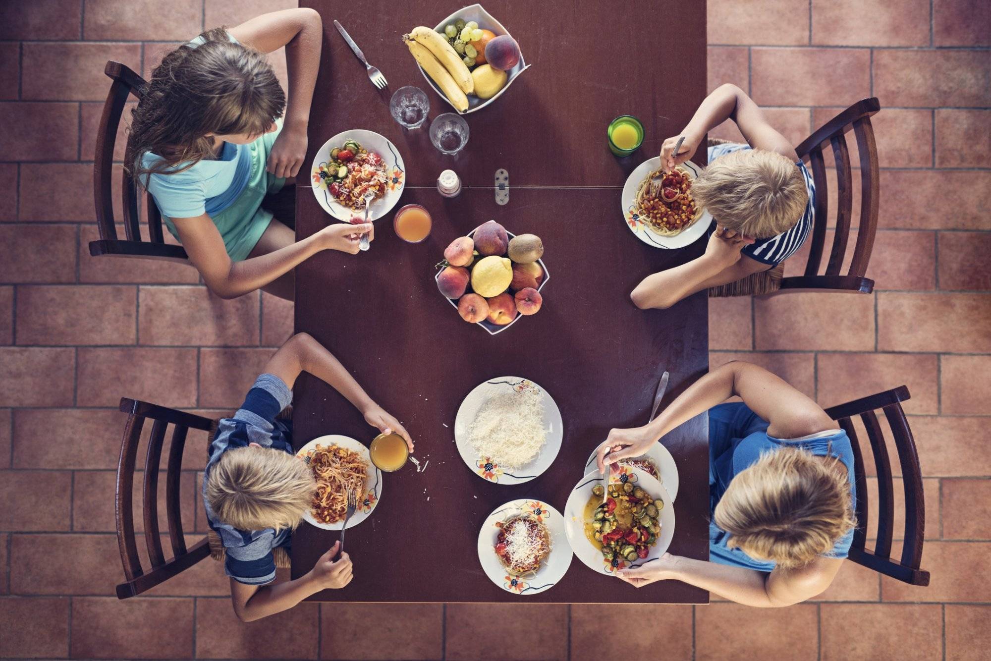 Family enjoying spaghetti lunch